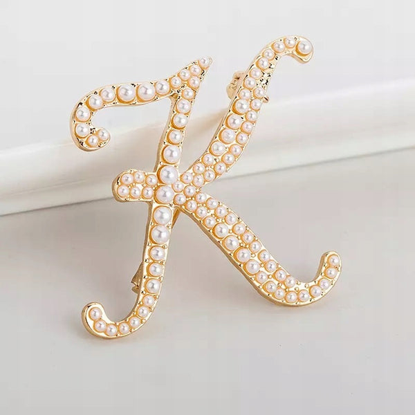 Golden letter K brooch with pearls