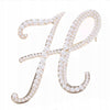 Golden letter H brooch with pearls