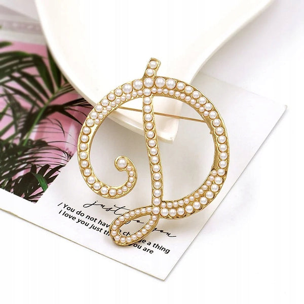 Golden letter D brooch with pearls