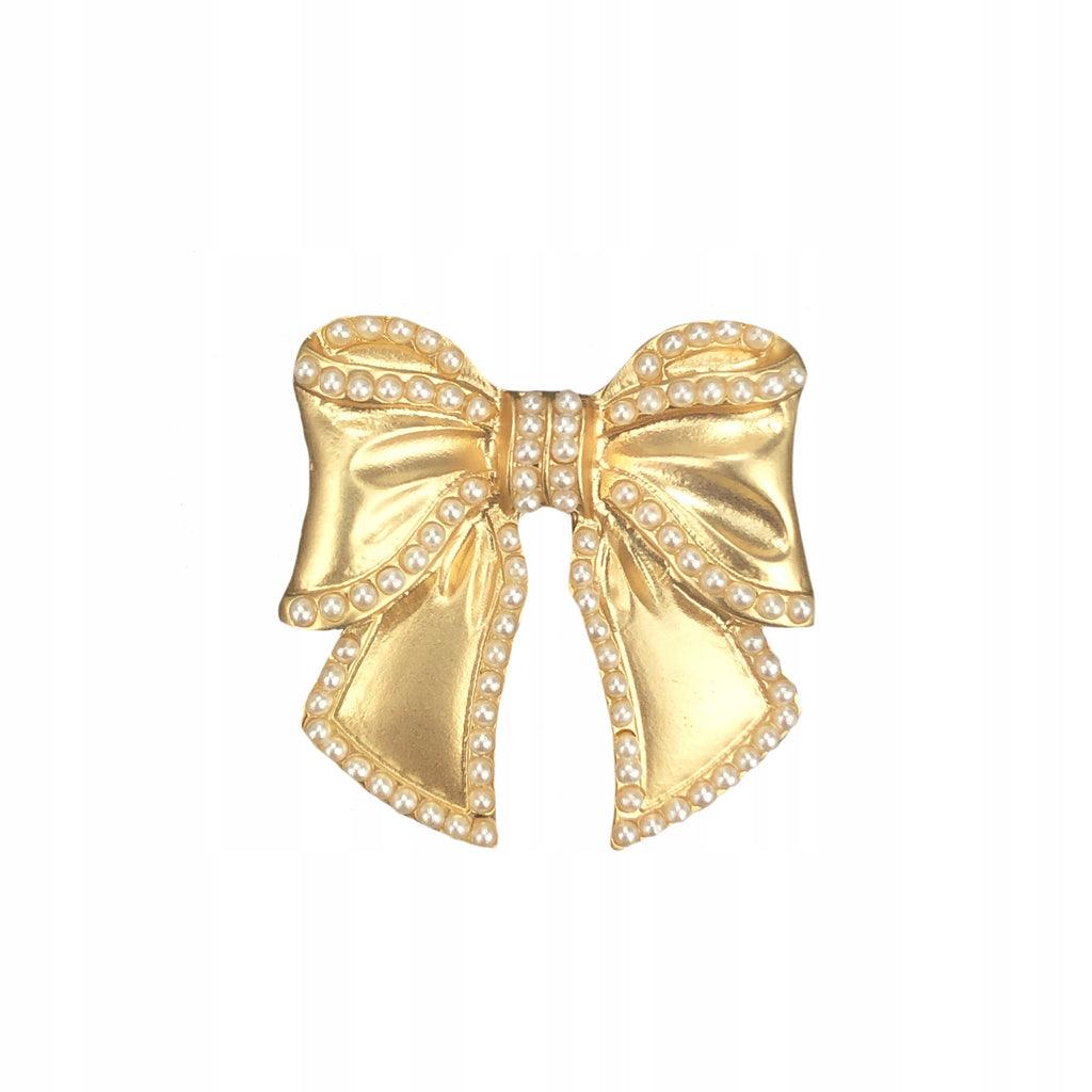 Golden brooch with a bow