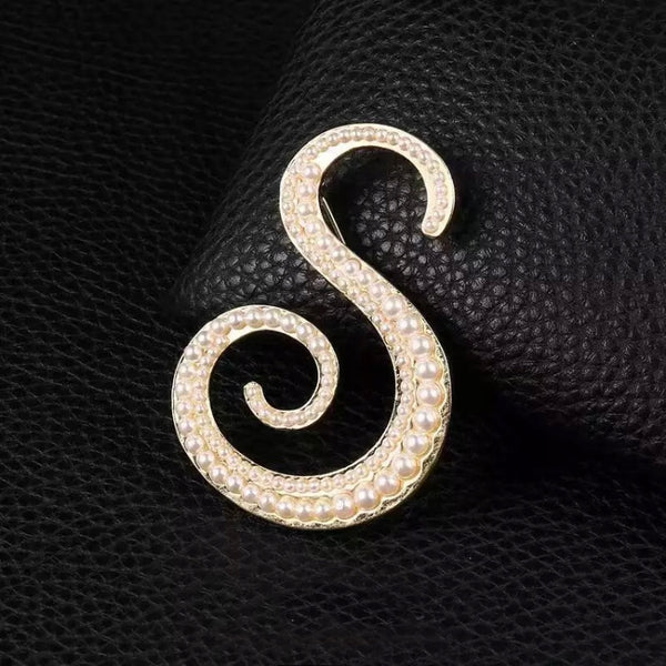 Golden letter S brooch with pearls