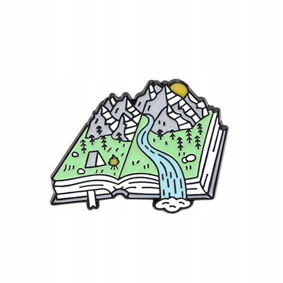 Mountain view on a book enamel pin