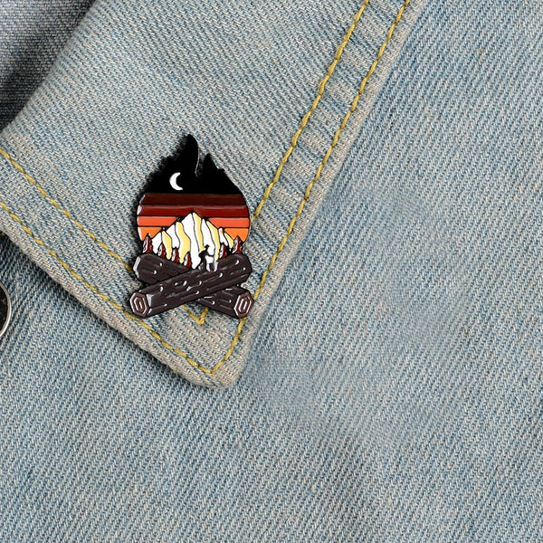 Bonfire with a mountain landscape enamel pin