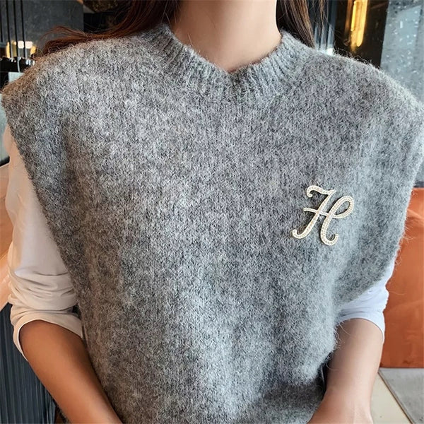 Golden letter H brooch with pearls