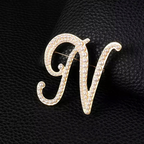 Golden letter N brooch with pearls
